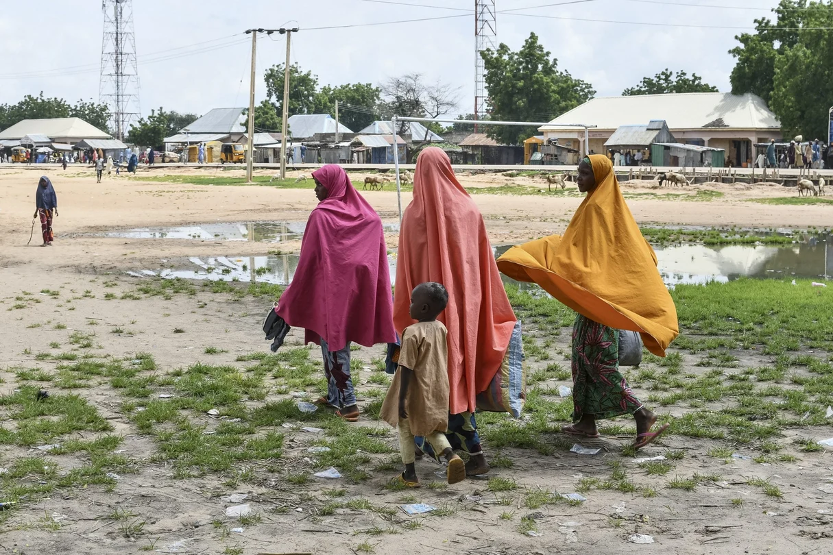 Survivors and family members of victims of a suspected Boko Haram attack walk in Babban Gide on September 4, 2024. At least 81 people were killed and several remain missing following an assault by presumed Boko Haram jihadists in Yobe State, northeastern Nigeria, local officials reported on September 3, 2024. Around 150 suspected Boko Haram terrorists, armed with rifles and rocket launchers, stormed the Mafa neighborhood on more than 50 motorcycles around 4 p.m. on Sunday,