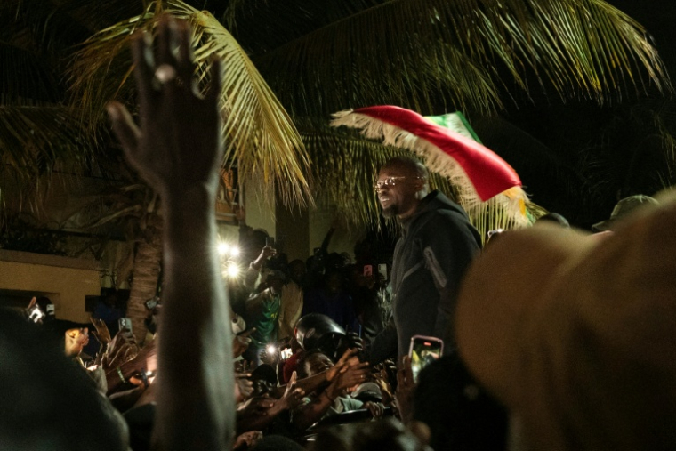 Supporters of Ousmane Sonko gather outside his Dakar home after his dismissal