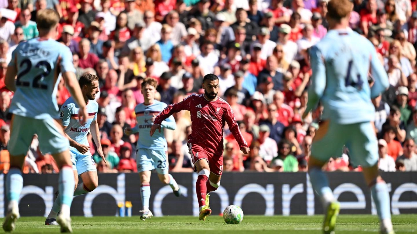 Liverpool players celebrate after securing Champions League qualification