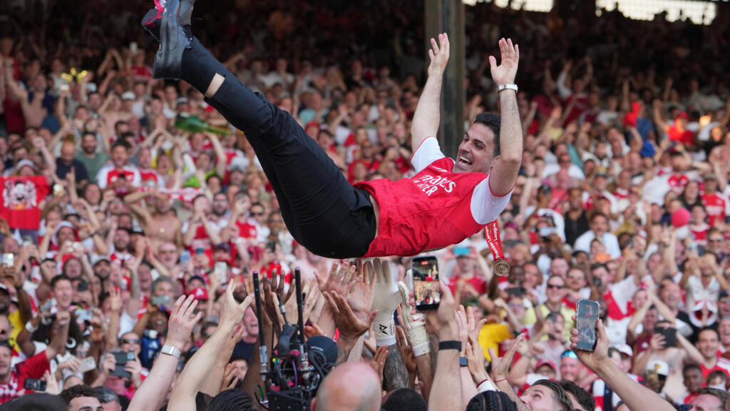 Arsenal manager Mikel Arteta is hoisted by players celebrating their Premier League title after the match between Crystal Palace and Arsenal in London, England, on Sunday, May 24, 2026.