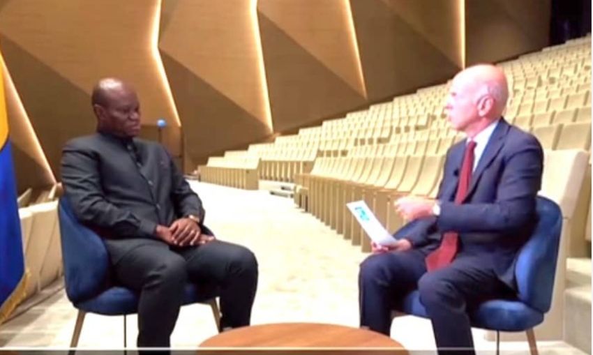 President Oligui Nguema seated with a journalist