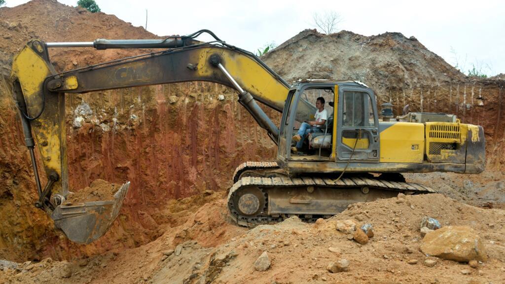 A Chinese mining employee operates a bulldozer at a mining site in Betare Oya, Cameroon, April 4, 2018.
