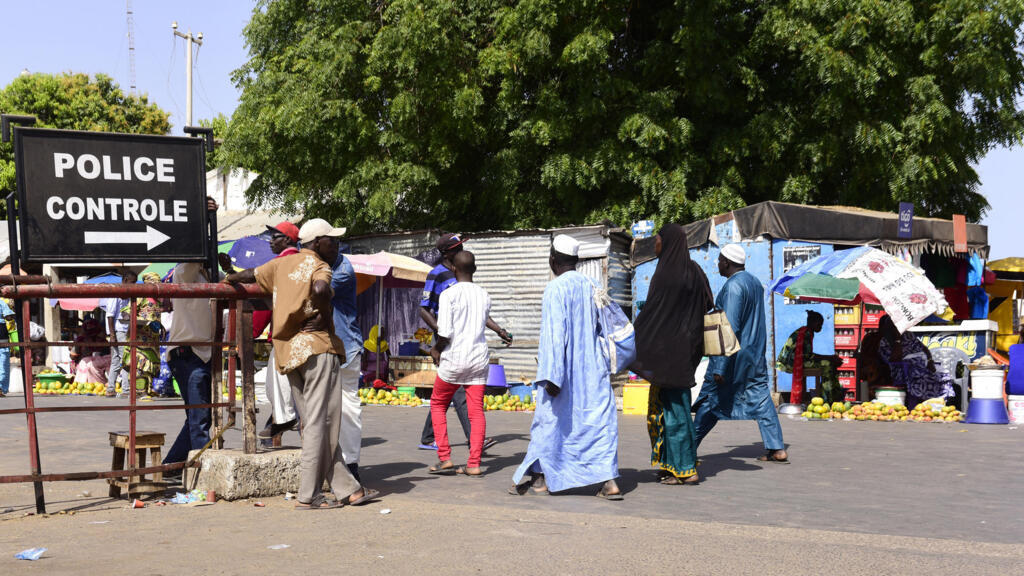 At Karang in Senegal, travelers pass through a police checkpoint in May 2016 en route to Gambia.