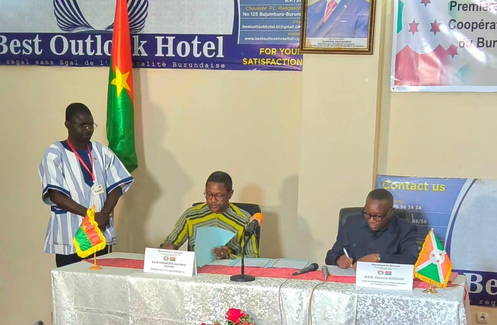 Delegates from Burkina Faso and Burundi shake hands during the signing of 14 cooperation agreements